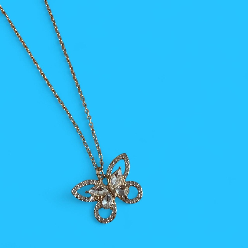 Gold butterfly necklace with diamond accents'